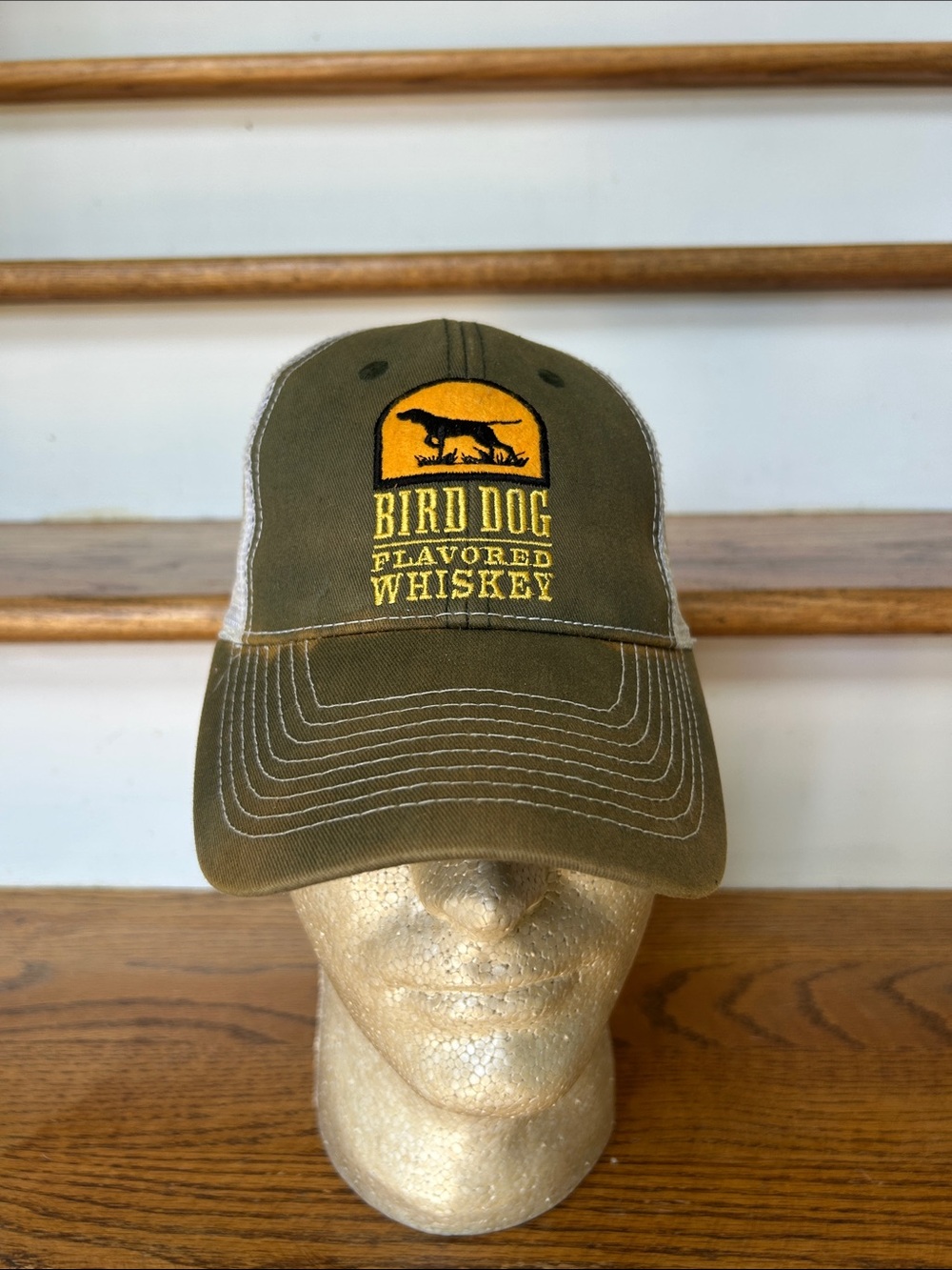 Bird Dog Flavored Whiskey Olive Mesh Trucker Hat in well loved condition